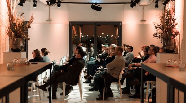 People sitting on chairs, attending an informative event