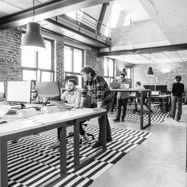 Modern open plan office with a couple of people working